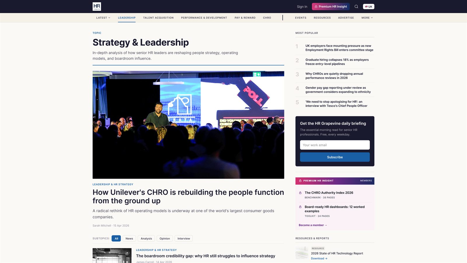 A topic hub for Strategy and Leadership: a title and short description, a lead feature with a photograph of a speaker on stage, a row of subtopic filters (All, News, Analysis, Opinion and Interview), then the first story in the list, with the most popular list, the daily briefing sign-up and premium reports in the right rail.